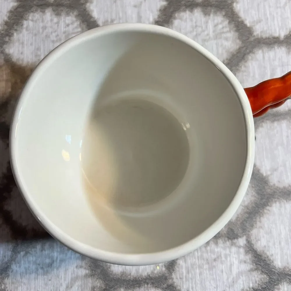 Artisan Mug with Floral Design and Orange Handle